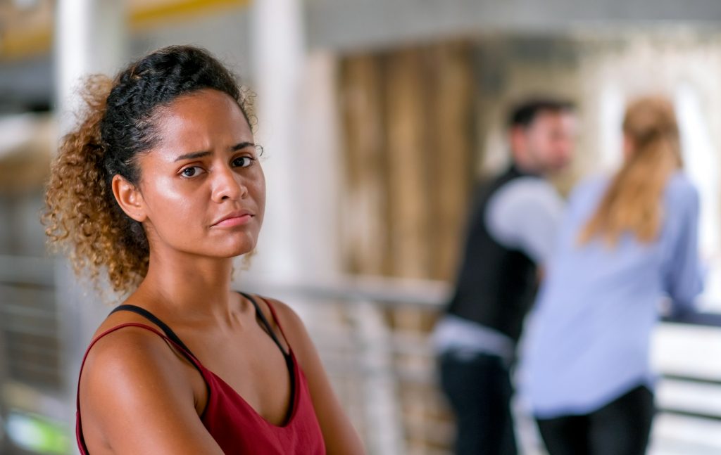 Dark tan skin mixed race woman act as upset or unhappy when she found her boy friend lie